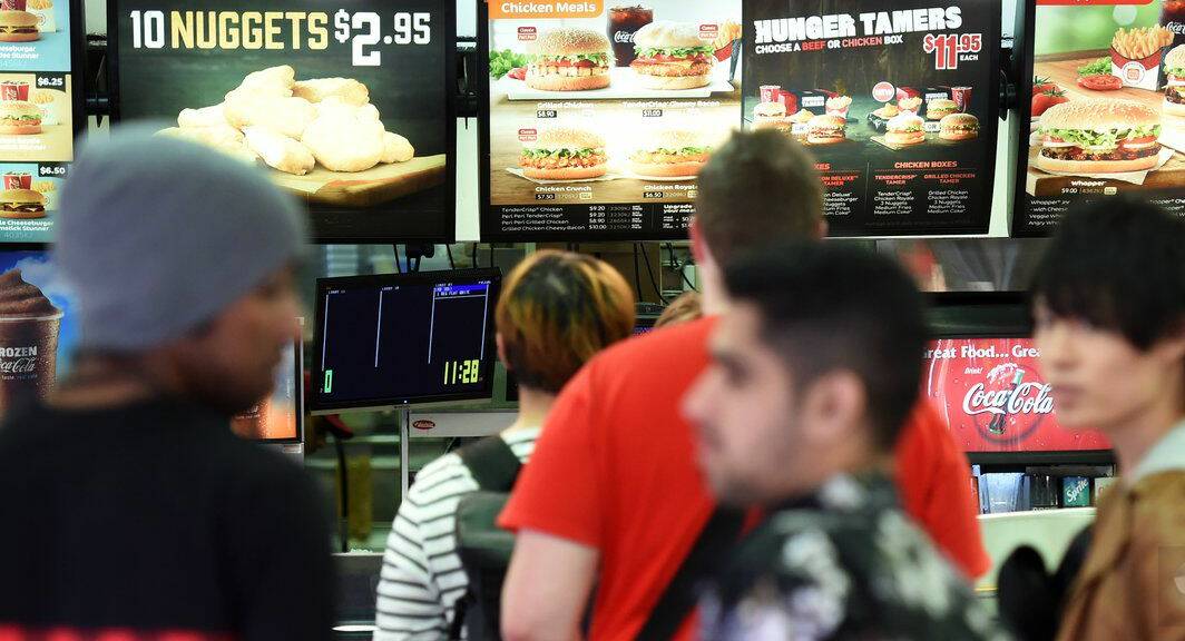 People line up to order at a fast food restaurant in Brisbane.