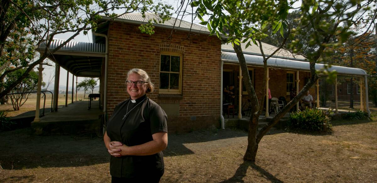 HISTORY: Anglican Church of Branxton Greta Lochinvar Priest in Charge Reverend Nicole Baldwin in front of Trinity House, which is 100-years-old this year. Picture: Marina Neil