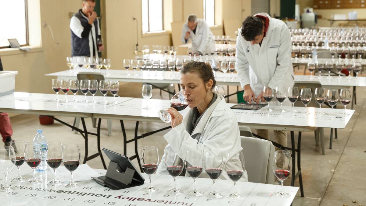  Jane Hoppe (front) judging a wine. Picture: Max Mason-Hubers