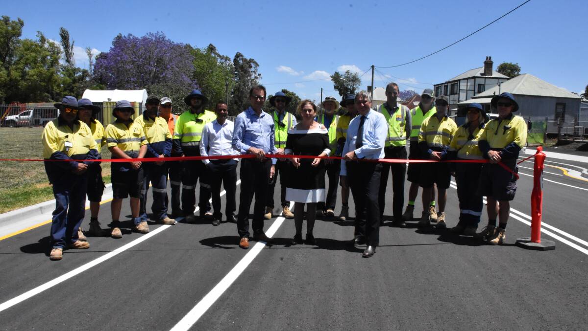 OPEN: Maitland City Council general manager David Evans, mayor Loretta Baker and engineering and design manager Kevin Stein cutting the ribbon with council staff.