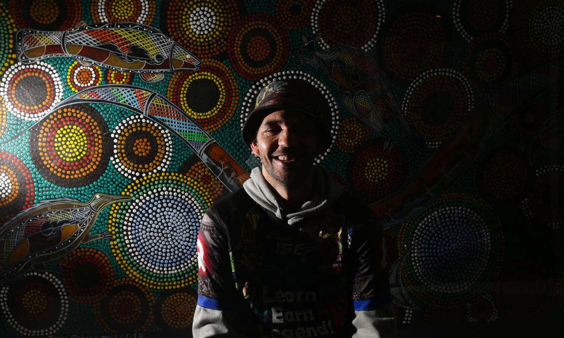 CREATIVE: Aboriginal artist John Robinson in front of the artwork. Picture: Jonathan Carroll