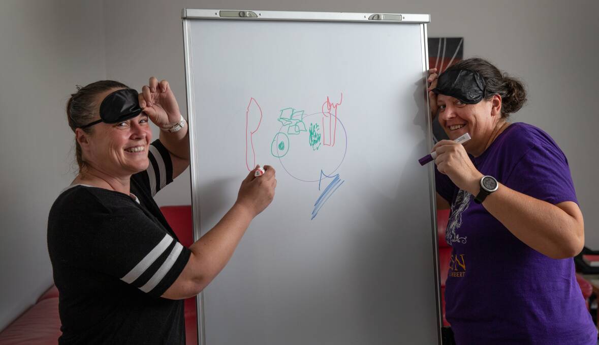 BLINDERS: Donna Oliver (left) and Sally Worth creating something unique on their white board. PICTURE: Marina Neil.