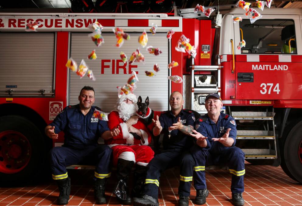 YUM: Firefighters Paul Conicella, Darren Lancaster and Wayne Chapman with Santa and racing greyhound, Jack. Picture: Marina Neil