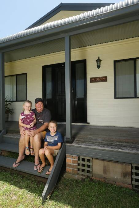 ICONIC: Craig Bailey, pictured with grandchildren Jack and Allie, bought Gillieston Heights' old community hall and is trying to find out its history. Picture: Jonathan Carroll