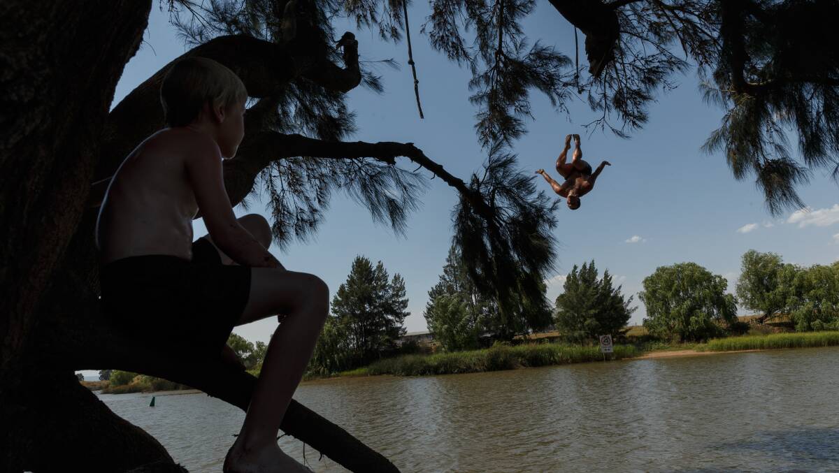 SPLASHING AROUND: People cooling off in the Hunter River at Morpeth on January 4, the hottest day of the season in Maitland. The temperature reached 45.1 degrees. Picture: Max Mason-Hubers
