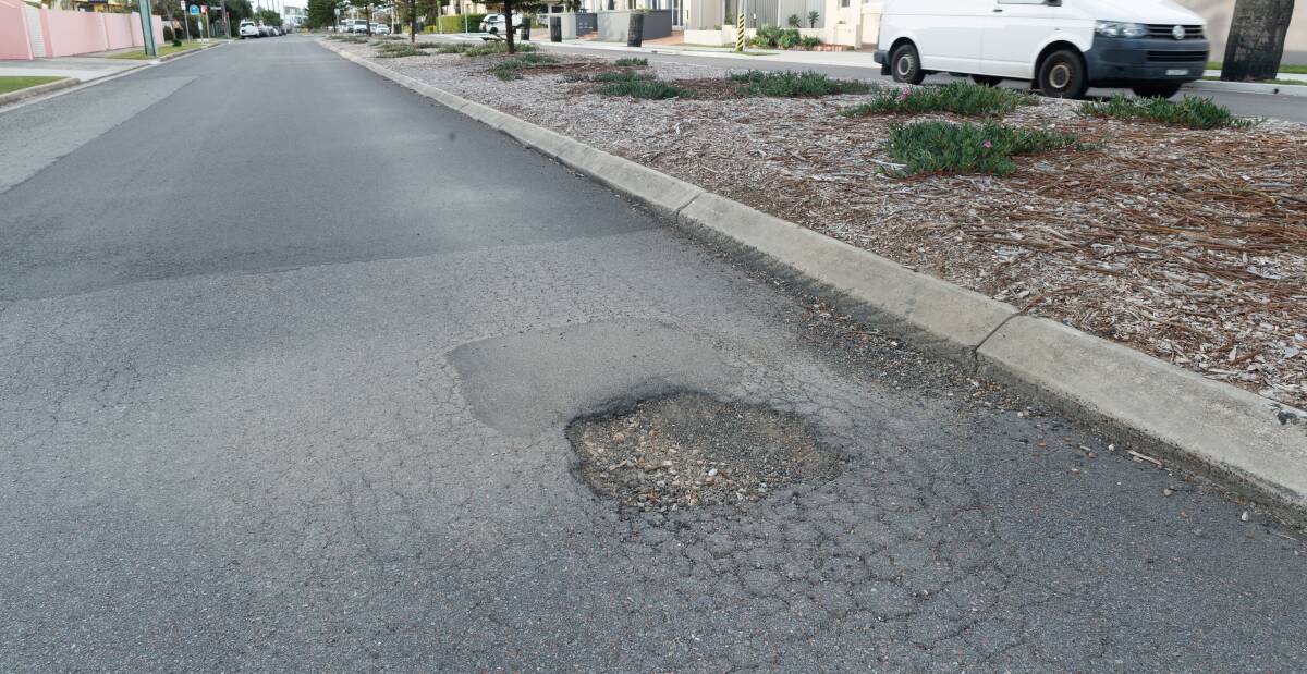 DAMAGE: A pothole on Watkins Street, Merewether. Customer pothole reports are up 161 per cent in Newcastle from two years ago. Picture: Max Mason-Hubers