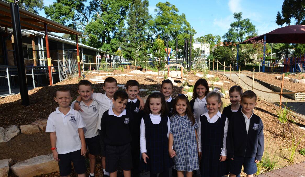 INCLUSIVE: East Maitland Public School kindergarten, year 1 and 2 students in front of the new "A Sense of Place" garden in the playground.