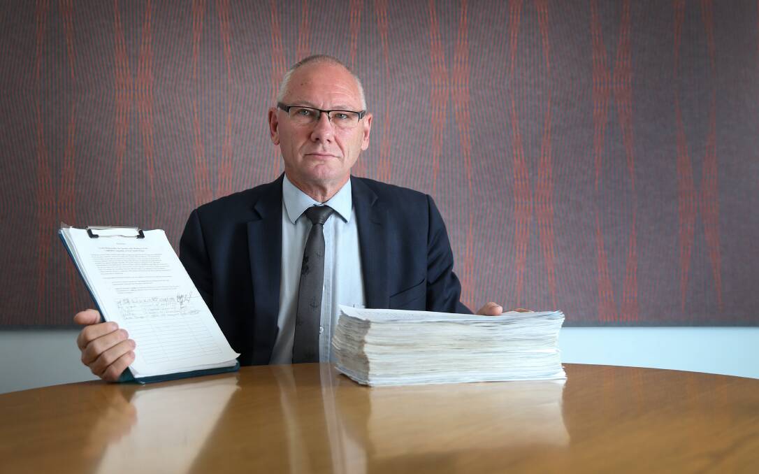 BIG ISSUE: Pastor Bob Cotton with his petition for stronger penalties for concealing child sex abuse, which has gathered 13,000 signatures. Picture: Marina Neil