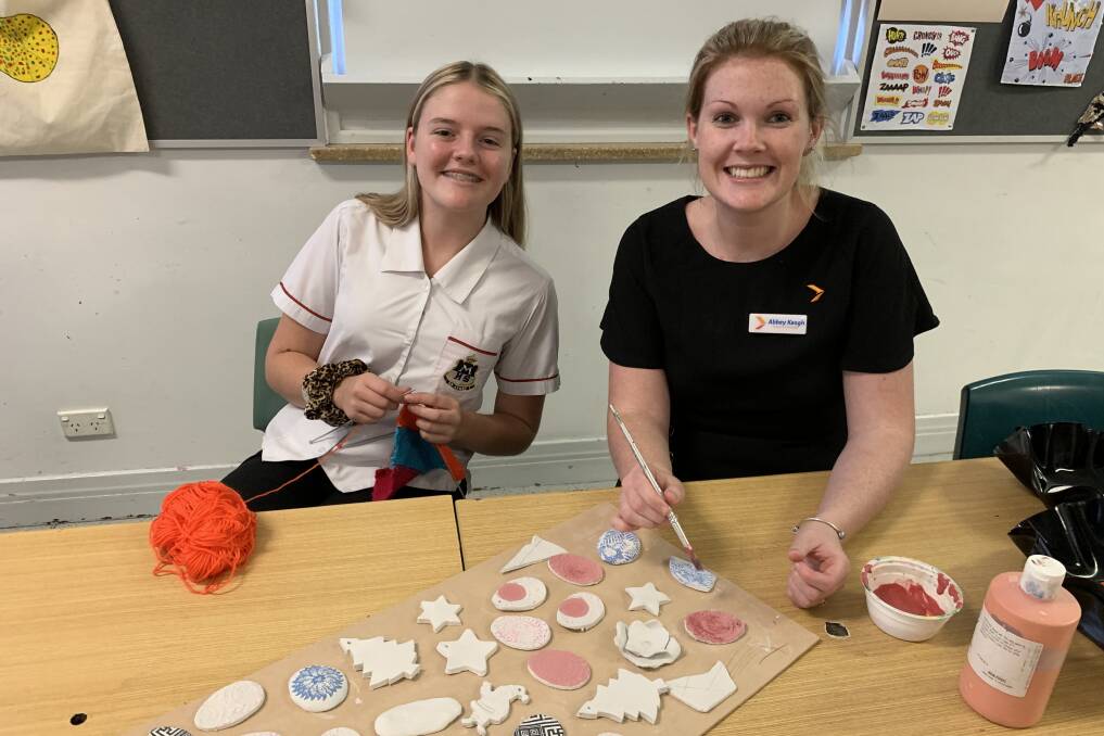 TEAMWORK: Maitland High School student Madison Churchouse and Greater Bank Rutherford branch manager Abbey Keogh preparing goods to be sold at the market. 