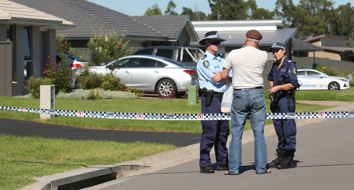 INVESTIGATION: A resident of the home and father of the 23-year-old who was stabbed speaks to police at the edge of the crime scene. Picture: Simone De Peak