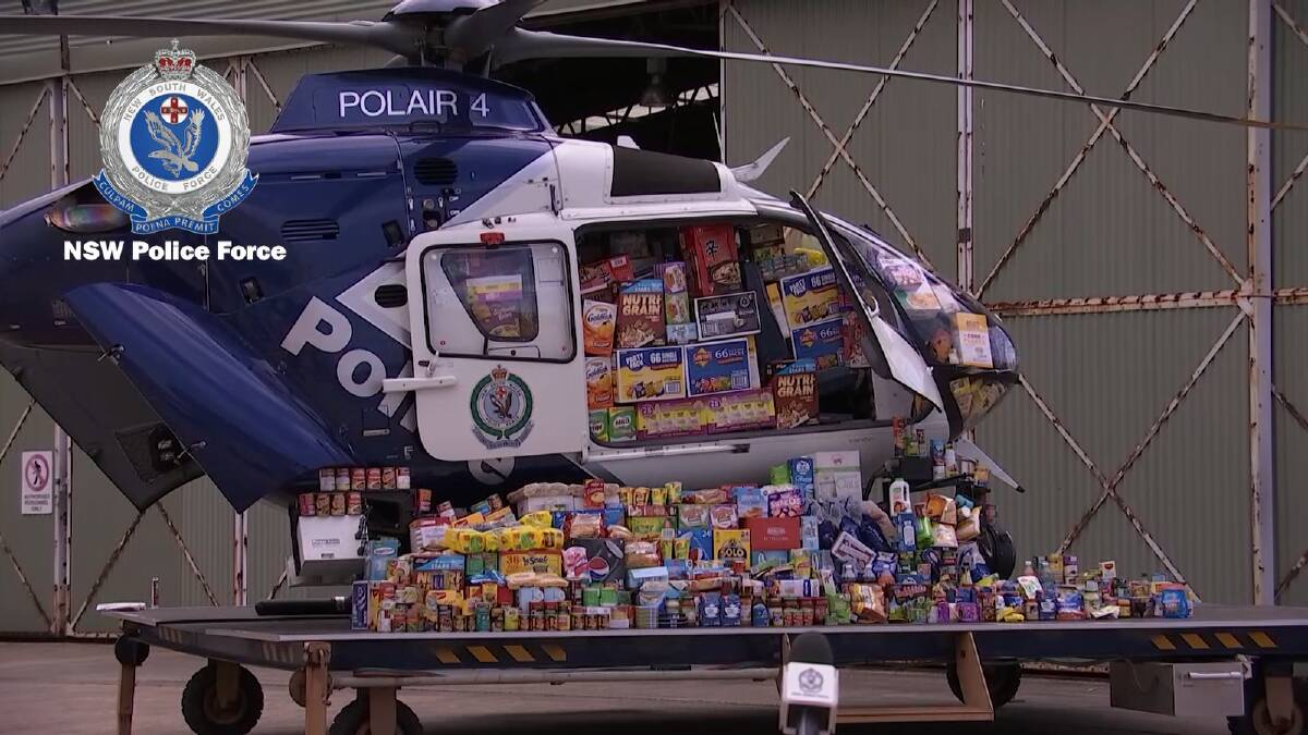 INITIATIVE: A police helicopter filled with donations to help farmers. Picture: NSW Police