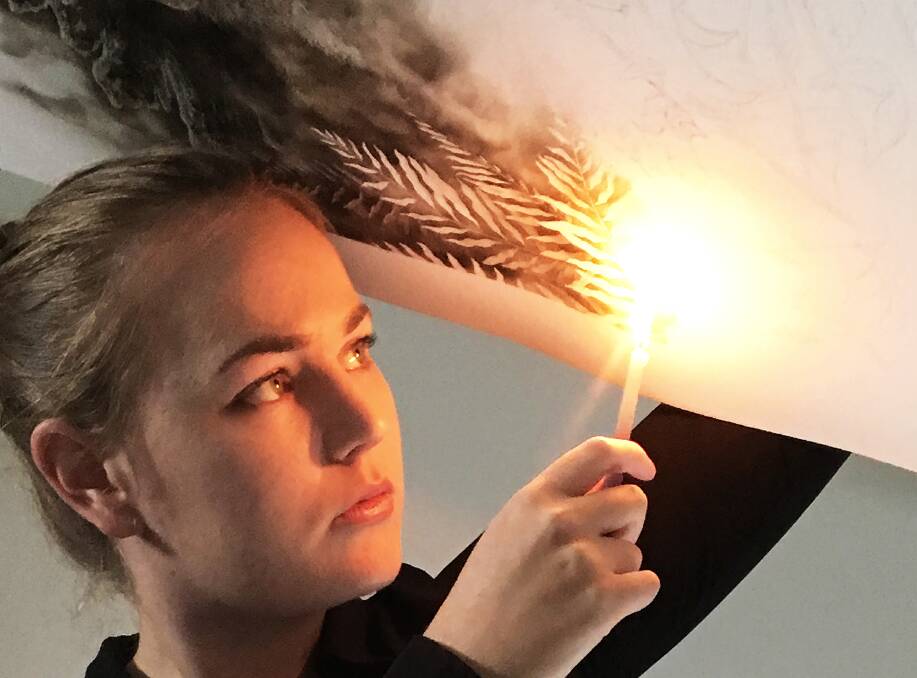 SMOKING: Victorian artist Maegan Oberhardt paints with fire and will hold an exhibition at Morpeth Gallery on November 23 and 24. PICTURE: Supplied.