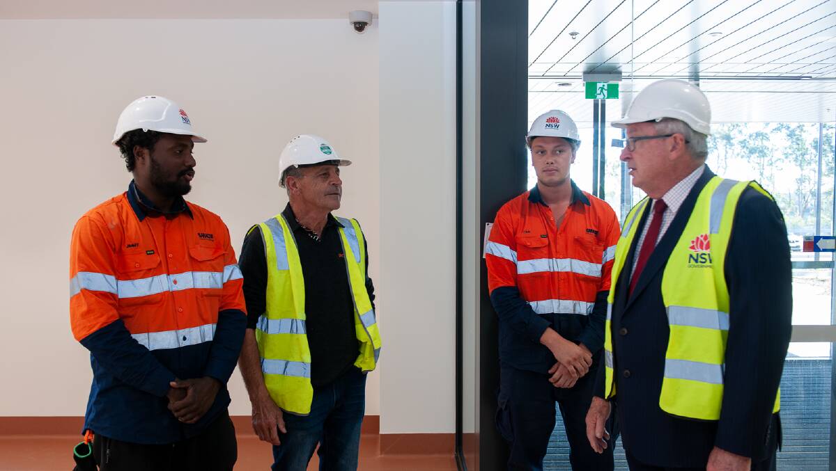CONSTRUCTION UPDATE: NSW Health Minister Brad Hazzard (right) chats with some of the construction workers during a tour of the new Maitland Hospital on Tuesday.