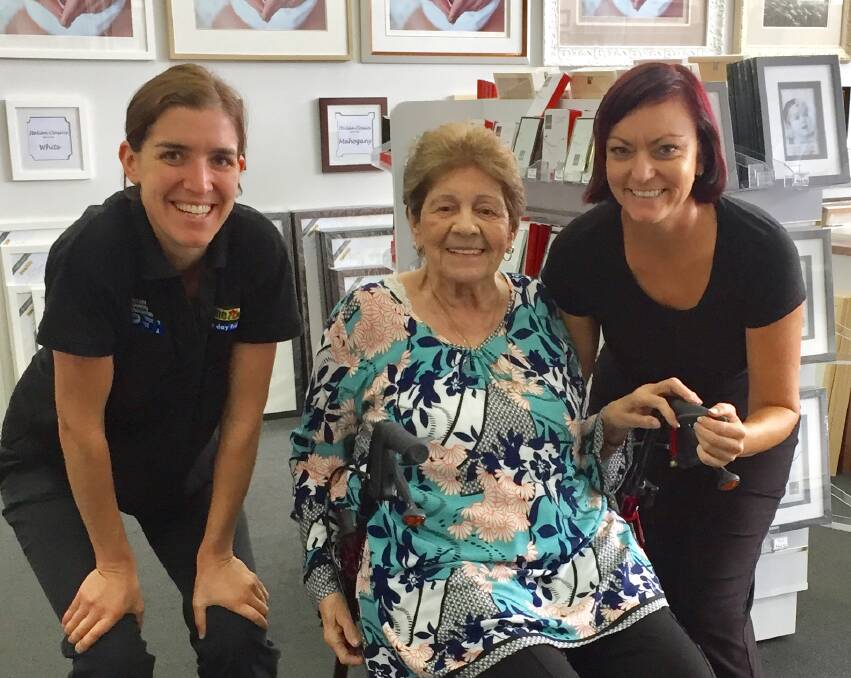 WORK OF ART: Ros Langley pictured with East Maitland Frame Today staff Sia Moulos (left) and Debra Atkinson after putting some of the finishing framing touches to her works. PICTURE: By Michael See.