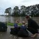 STRANDED: Alison Urch with her children after being evacuated by boat from Gillieston Heights where she was stranded overnight while visiting family. PICTURE: Simone De Peak