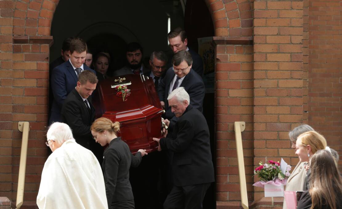 REST EASY: Mrs Allen's husband David senior (bottom right) and son David next to him, help other pallbearers carry Mrs Allen's casket out of the Sacred Heart Church. PICTURE: Simone De Peak.