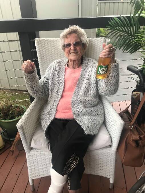 CHEERS: Mrs Nixon enjoying a beer to mark her 100th birthday.