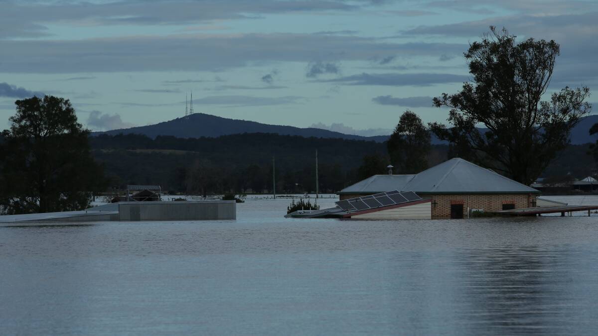 ENGULFED: A view from the New England Highway at Maitland of a property engulfed by floodwaters. PICTURE: Simone De Peak.
