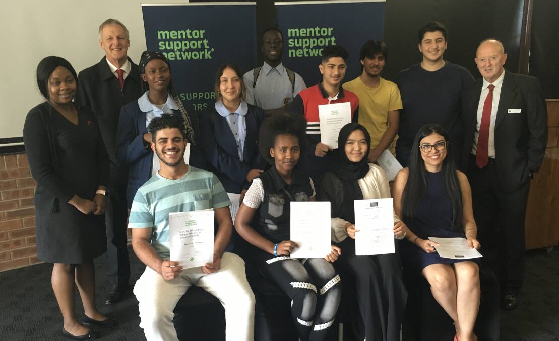 SCHOLARS: Martha Nyabadza and Geoff Seccombe (both left) and Pat O'Flaherty (right) with the group of refugee students representing seven nationalities. PICTURE: Supplied.