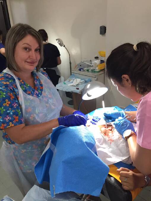 THEATRE: Heidi Avery and Dr Armi Aganan operating on one of the patients.