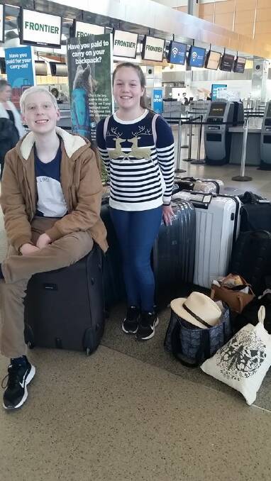 NO PLACE LIKE HOME: Johey and his sister Isabella at the airport check-in before their flight home. PICTURE: Supplied.
