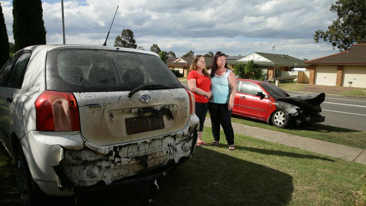 FEARS: Sisters Kathryn Blakemore (left) and Linda Carter pictured with their cars after the Monday morning fire attack. PICTURE: Jonathan Carroll. 