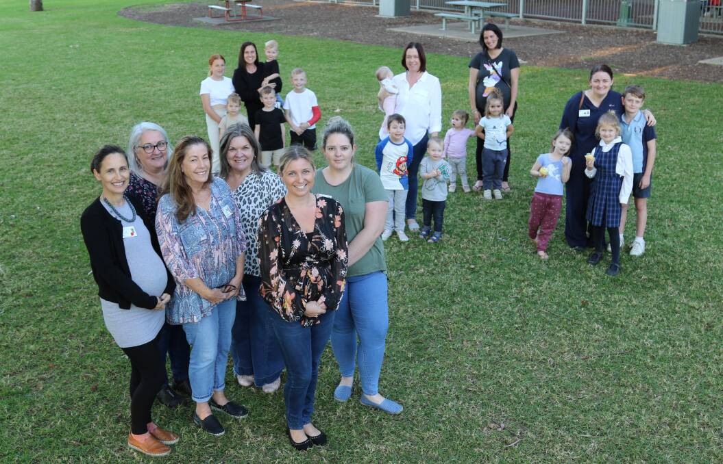 BABY LOVE: Midwives (front) Karen Grosse, Leah McDonnell, Rachel Upton, Casey Wiggins, Denise Wilde and Annette Wilson with Casey Currie, Tiffany Dever, Emily Muir and Ashley Booth and some of their children delivered under the Maitland program.