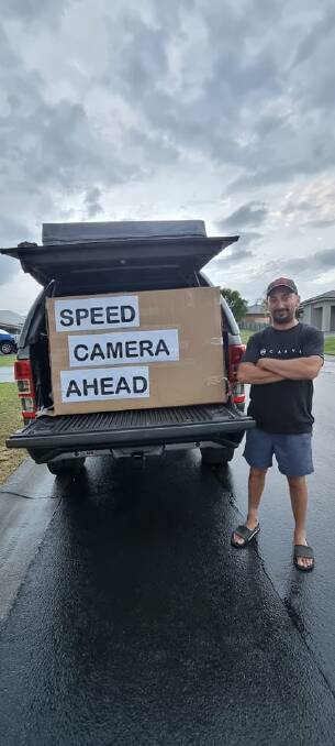 FINE JOB: Carl Dimarzo pictured with the sign that's helping save motorists hundreds of dollars in fines. PICTURE: Supplied.