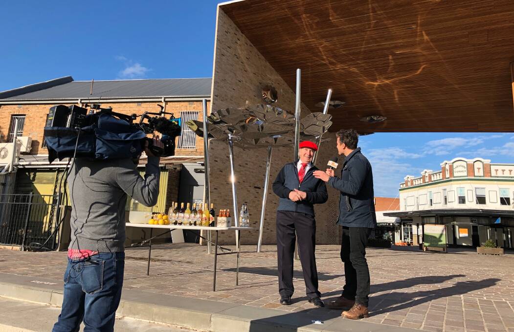 GOOD MORNING: Seven Network's Sunrise weather presenter James Tobin pictured interviewing Morpeth businessman Trevor Richards during a live weather cross. PICTURE: Destination NSW.