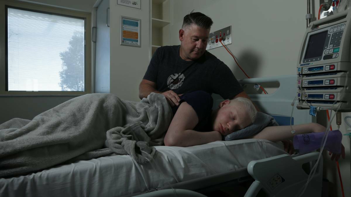 TREATMENT: Johey and dad Scott during treatment at John Hunter Hospital PICTURE: Simone De Peak.