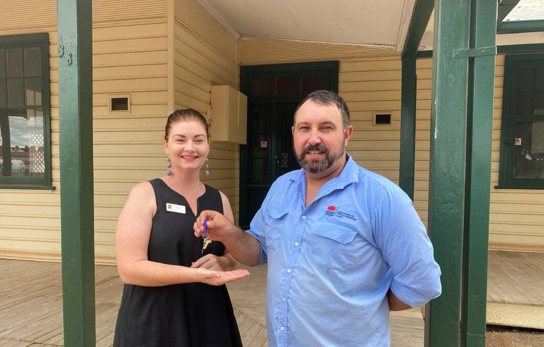 Anthony Azevedo from Crown Lands Bourke office hands over the keys to Alicia Tiffen from CatholicCare Wilcannia-Forbes. Photo: CONTRIBUTED