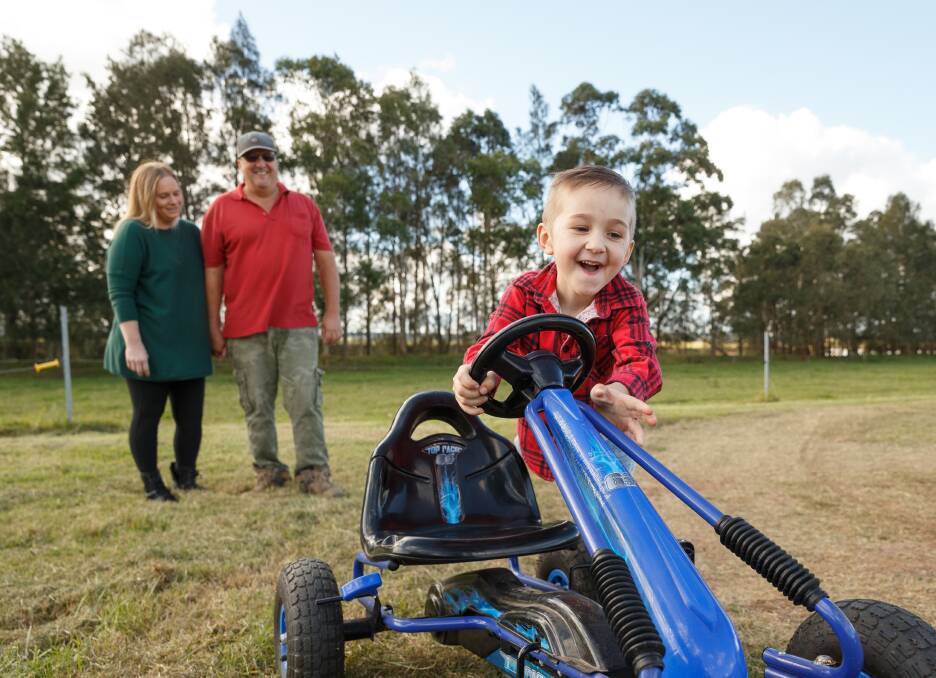 FIRING ON ALL CYLINDERS: Brayden Grugeon is all smiles as he enjoys the yard woith mum Kim and dad Anthony. Picture Max Mason-Hubers. 