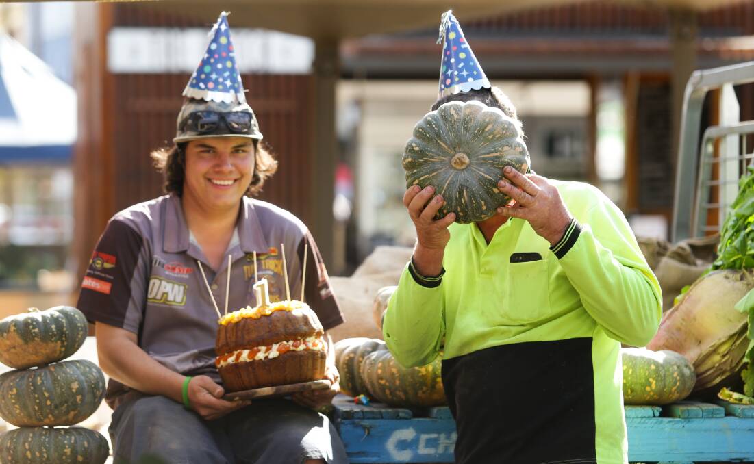CELEBRATION: Matthew Dennis, right, and his son Liam Dennis, left, with pumpkins and pumpkin cake for the Slow Food Earth Markets Maitland 1st birthday. Picture: JOnathan Carroll