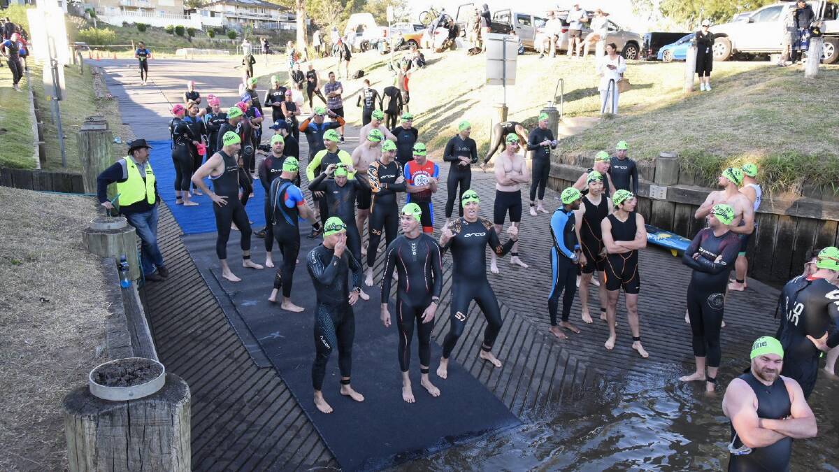 INTO THE RIVER: Entrants await the start of their race, kicking off with a swim in the Hunter River. 