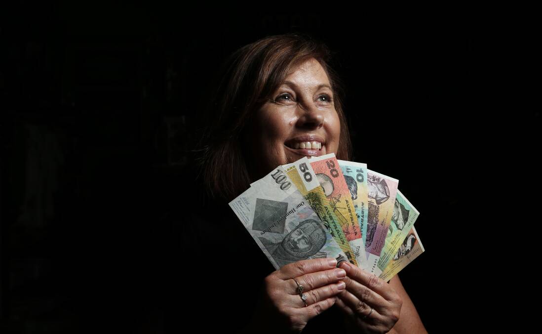 MONEY TALKS: Campbells Store team member Sue Jarrett with some rare notes in the lead up to the coin and notes evaluation day. Picture Simone De Peak.