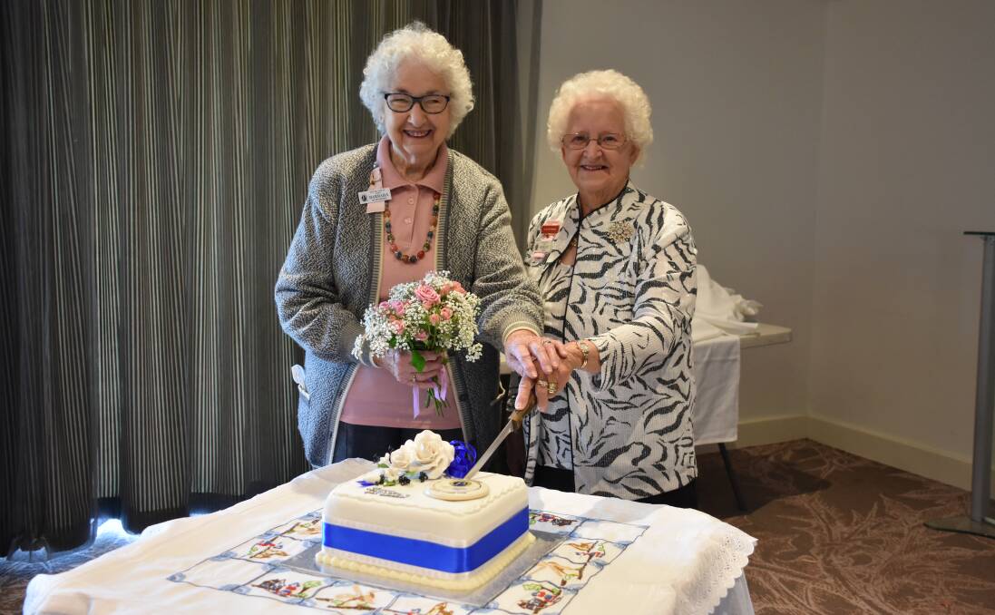 A CUT ABOVE: Barbara Humphries and Shirley Jones cut the cake in this week's birthday celebration. Picture: Belinda-Jane Davis
