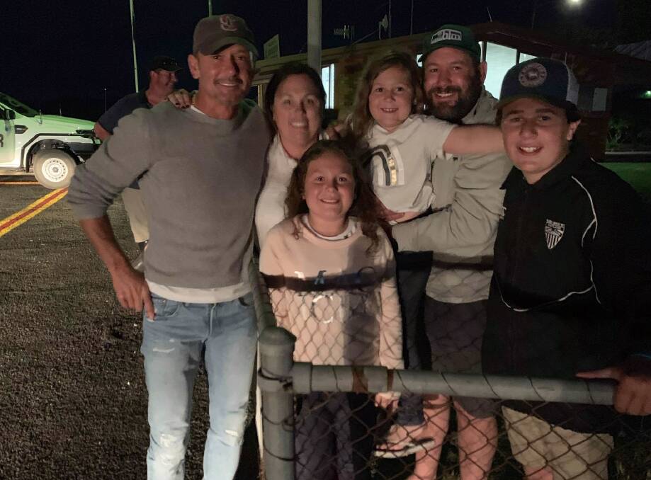 HEY MATE: Country music ace Tim McGraw at Deniliquin Airport with the Lewer family, Lindsey, Matilda, Audrey, Daniel and Oliver.