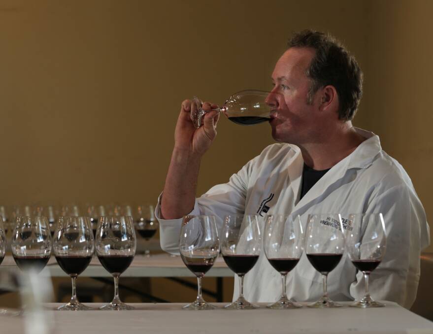 HARD WORK: Senior judge Nick Paterson tasting some Hunter shiraz which was a strong category. Picture: Simone De Peak  