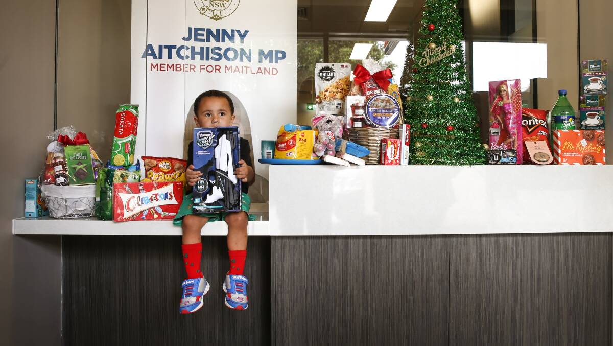 WORTHY CAUSE: River Upton, 3, with some of the toys waiting to go to needy families at Jenny Aitchison's Maitland office. Picture: Marina Neil  