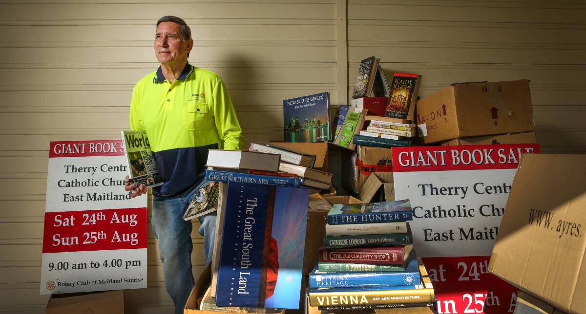 NOVEL IDEA: Vice President Rotary Club of Maitland Sunrise, Keith Pearson with some of the books that will be on sale. Picture: Marina Neil