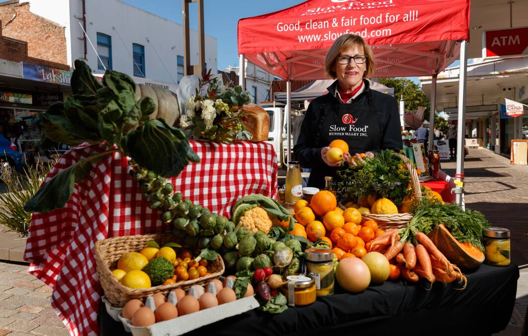 It's citrus season at Maitland's Earth Markets. Pic shows Slow Food Hunter Valley secretary Helen Hughes with a display of winter fruit & veg produce from the market's local growers and makers. Thursday 17 June 2021. Picture Max Mason-Hubers MMH / Newcastle Herald / ACM