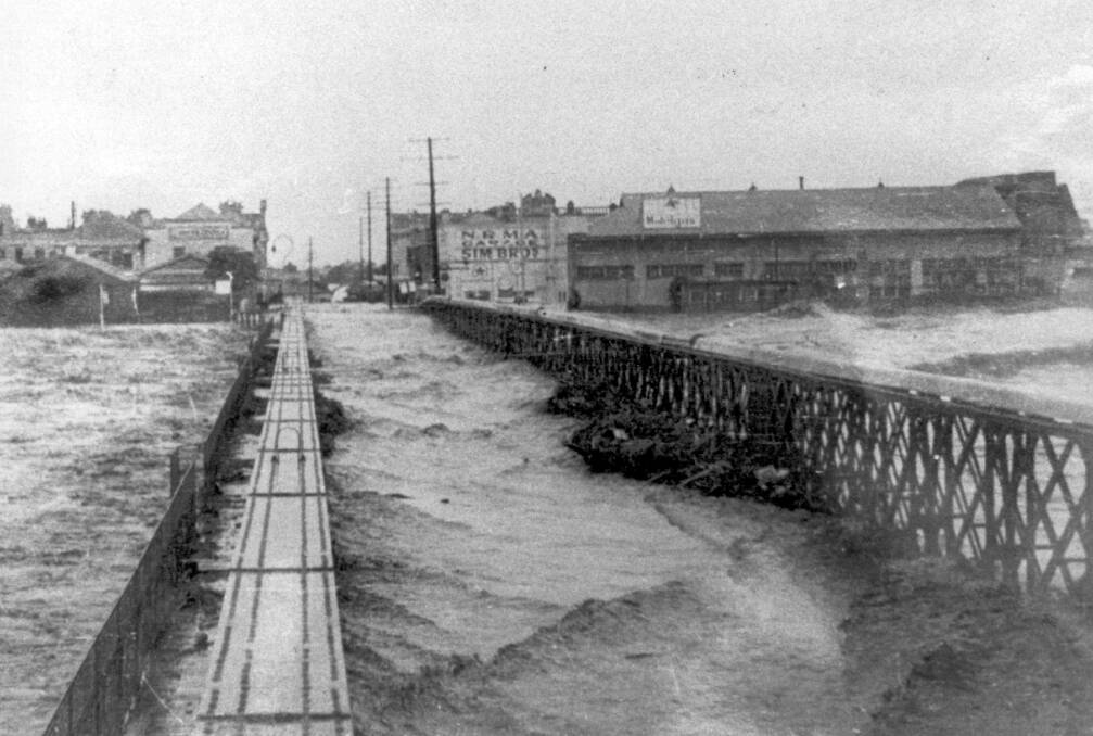 1955: The old Belmore Bridge during the great 1955 flood which sparked discussions about whether to relocate the township to higher ground.. 