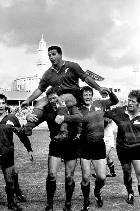 COURAGE: John Sattler with a broken jaw, carried off by his Souths teammates.