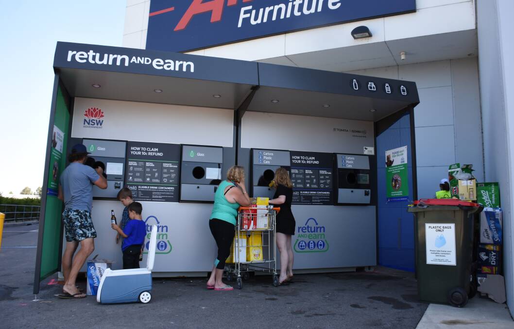 Open for business: The Return and Earn container deposit machine at Rutherford on Sunday morning. Picture: Lachlan Leeming 