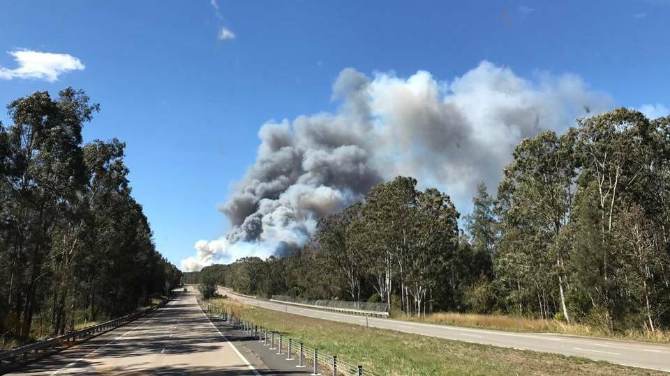 An empty Pacific Highway after a bushfire closes the road at Twelve Mile Creek. Picture: Fire and Rescue Raymond Terrace