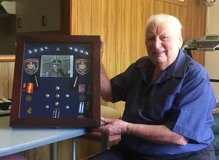 Memories: Former Maitland councillor and prison guard Ray Fairweather with some of his NSW Corrective Services memorabilia. Picture: Lachlan Leeming 