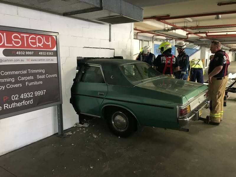 Stuck: The car that smashed through the wall at Rutherford Marketplace on Saturday, triggering an evacuation of the centre. Picture: Amy Campbell