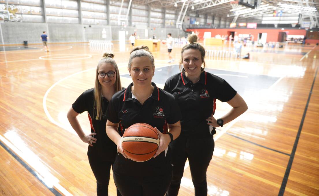 Driving to the basket: Mustangs Jo Everett, Kellie Fox and Casandra Screen are excited for Saturday's semi-final clash against Bathurst. Photo: Lachlan Leeming. 