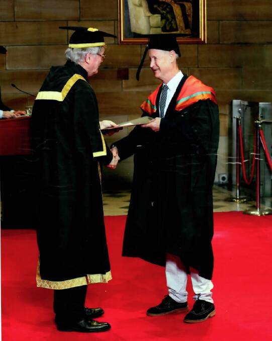 Maitland's Chris Richards (right) is presented his Masters at a University of Sydney graduation ceremony earlier this year. 