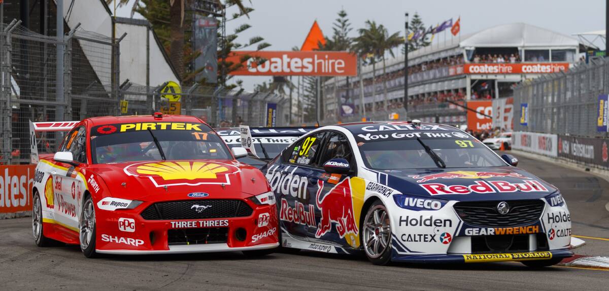 IN FRONT: Shane van Gisbergen leads Scott McLaughlin into turn one on the first lap of today's Newcastle 500 race. Picture: Mark Horsburgh